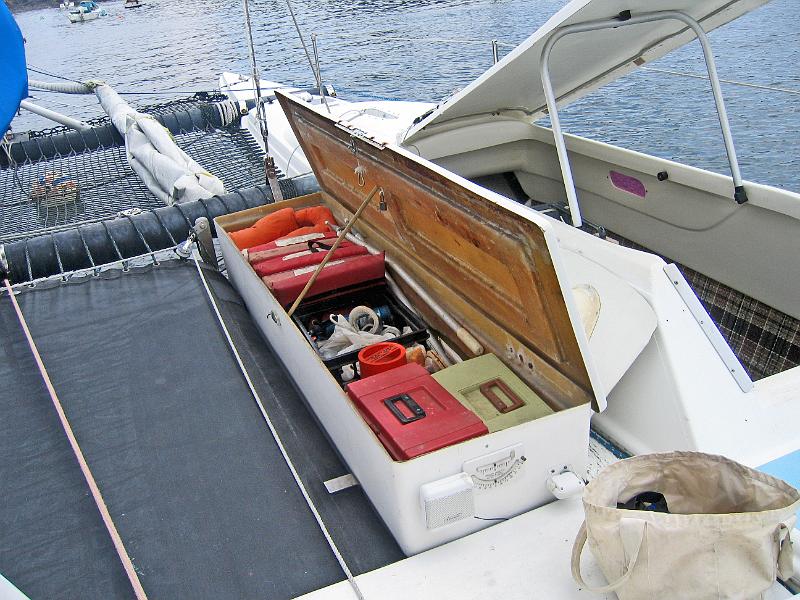 wavemagic_at_mooring31.JPG - Wave Magic at Mooring- One of two deck boxes open.  This one is dry stuff including , tools, emergency gear, first aid.  Similiar box on other side boat has wet stuff including anchor and rode, extra lines.